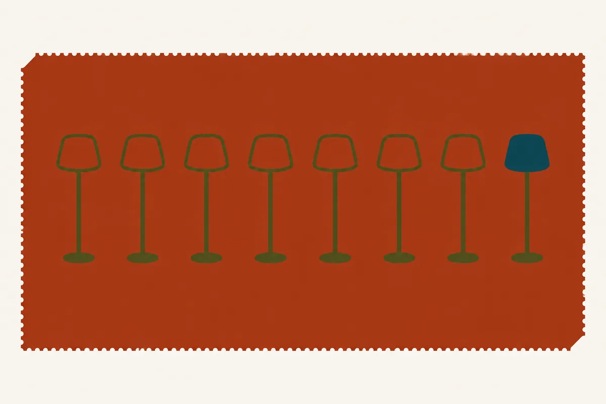A row of identical unlit table lamps, with only the last one at the far end switched on.
