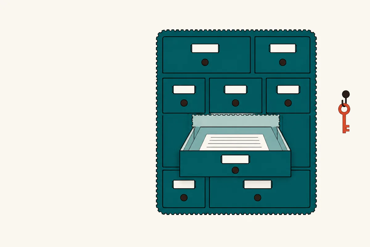 A wall unit of drawers with one drawer pulled out holding a blank slip, a pale panel behind it and a key on a hook.