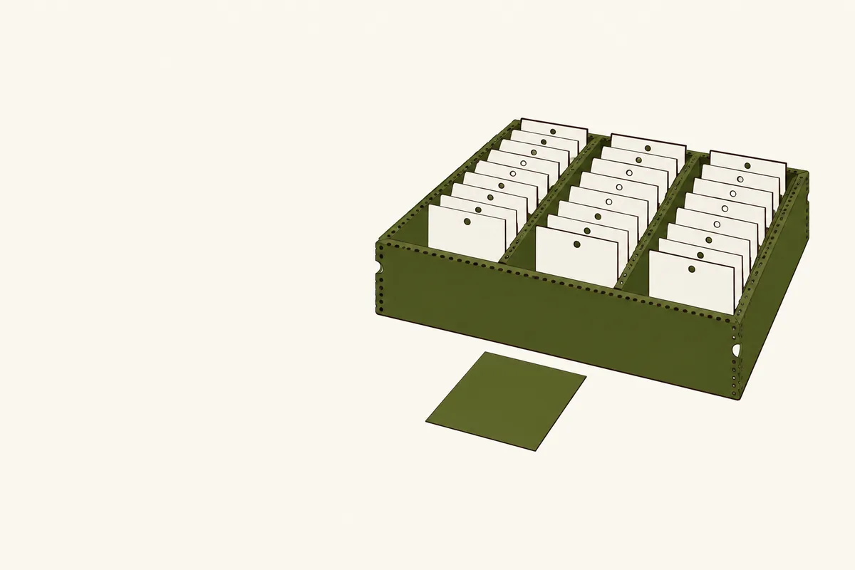 Identical slips filed upright in a tidy olive tray, each punched once, with a single blank slip lying in front.